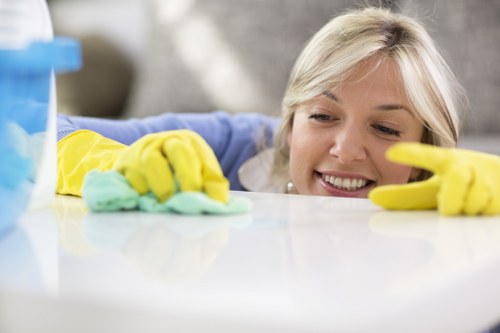 Technician applying careful carpet cleaning methods with protective gear